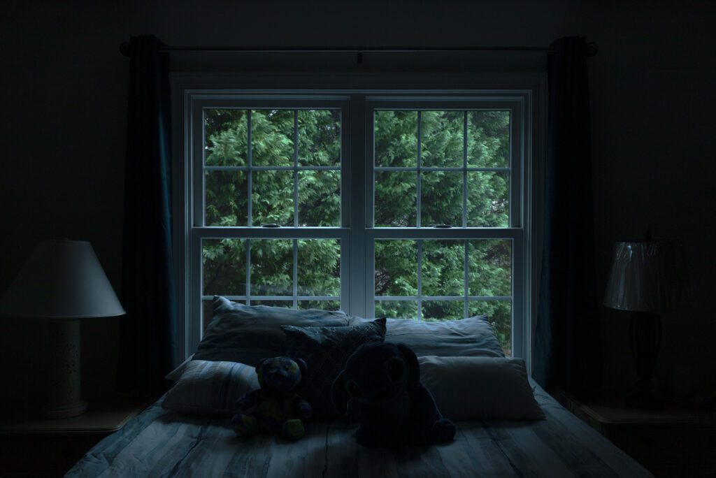 window behind bed at night