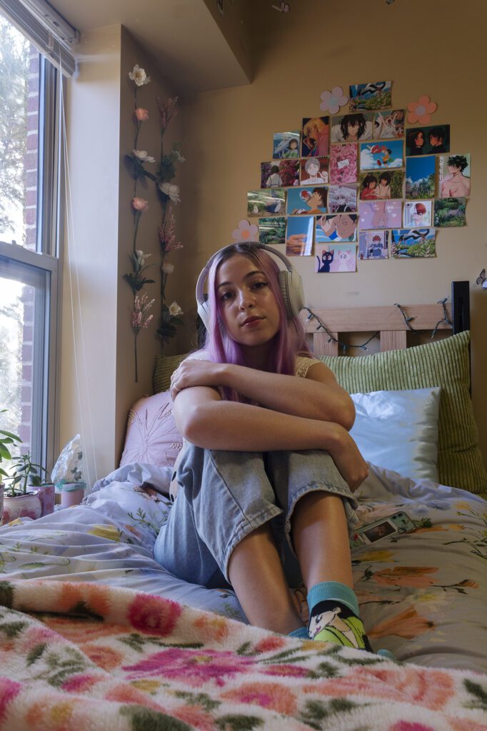 Natalie sitting on bed